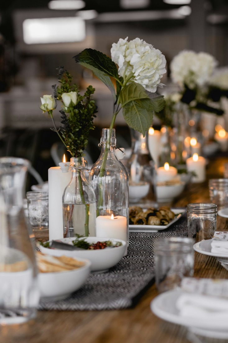 A candlelit table with white hydrangeas