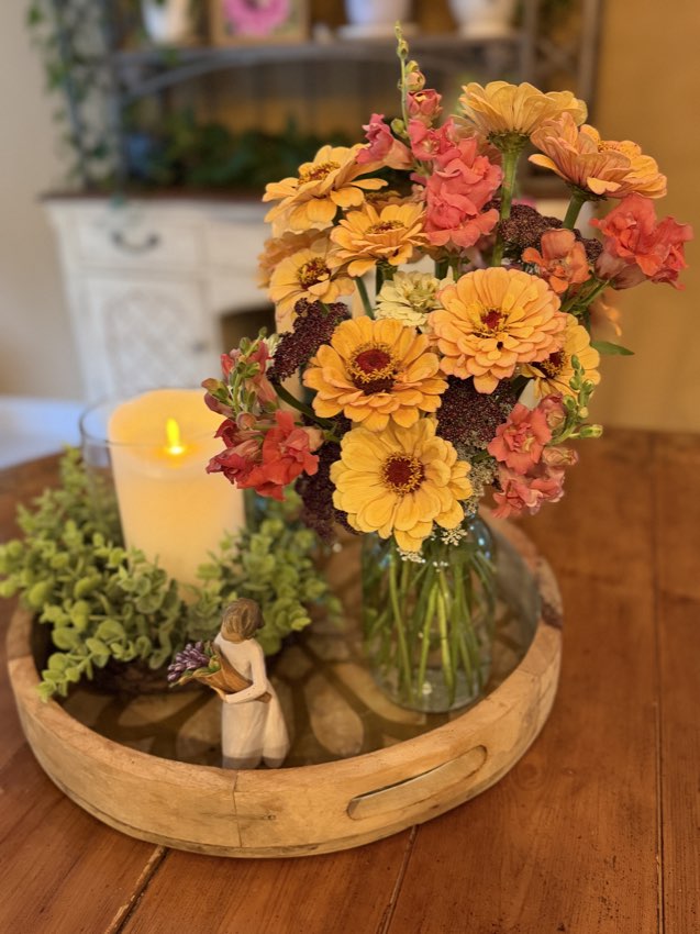 A candle centerpiece with fresh flowers
