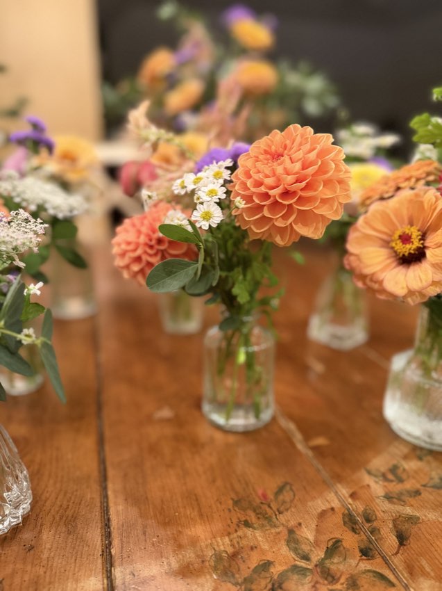 Bud vases of fresh flowers on a table