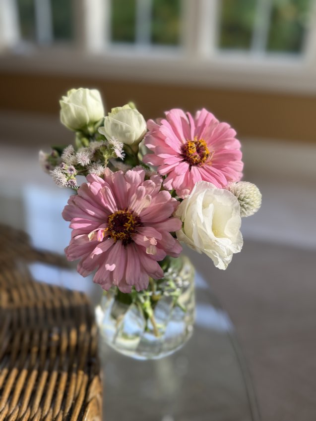 A soft pink bouquet in a glass vase
